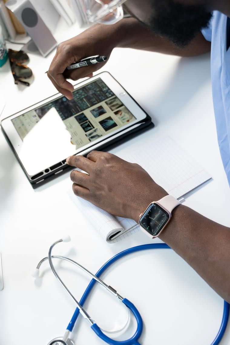 Doctor reviewing records on a tablet — Qlaio supports independent healthcare specialists