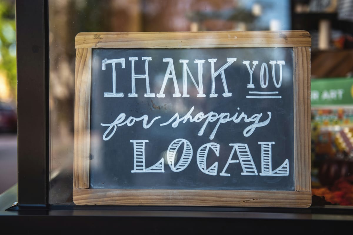 Thank you for shopping local sign in a storefront window